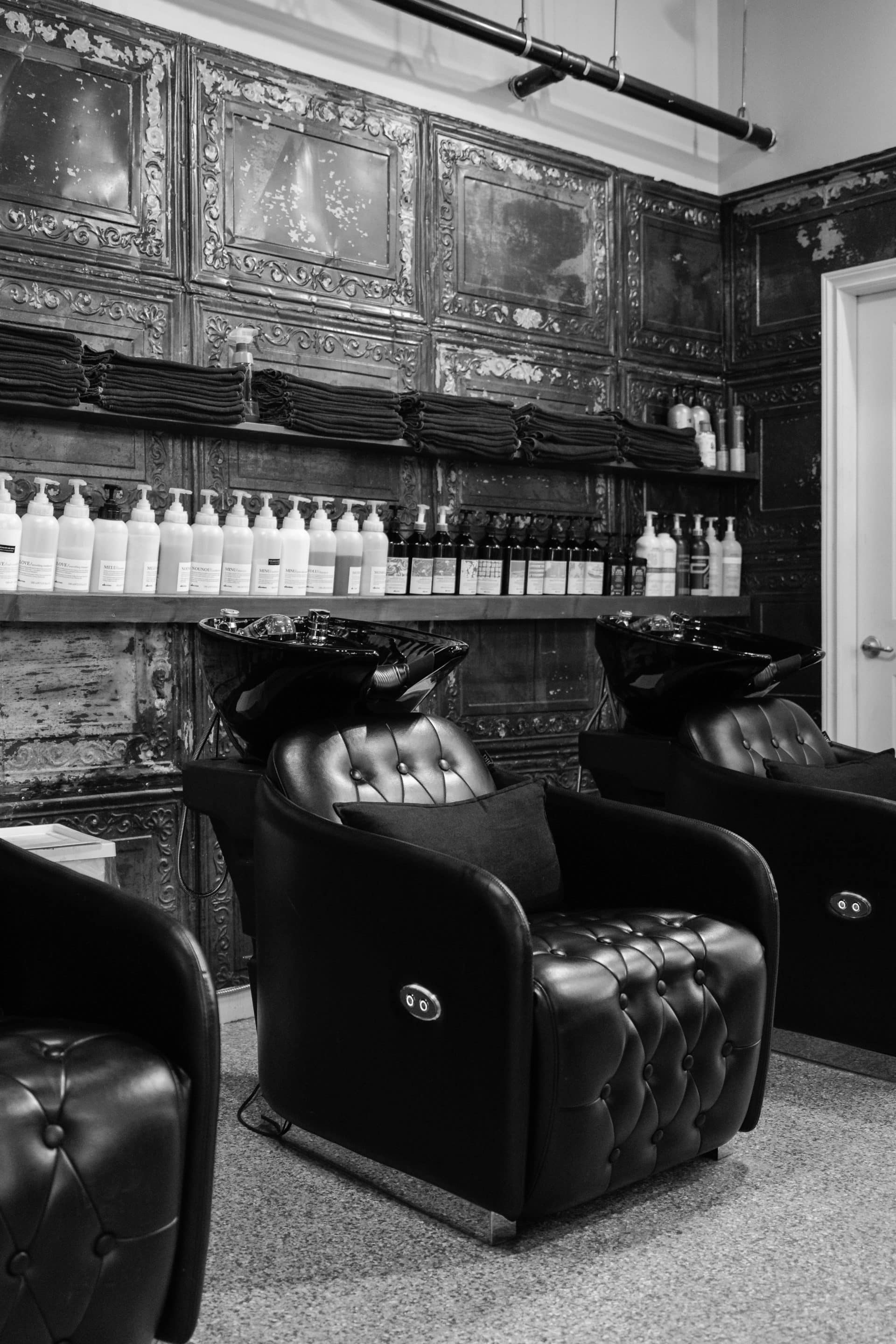 Image depicting stylist and clients in Salon.